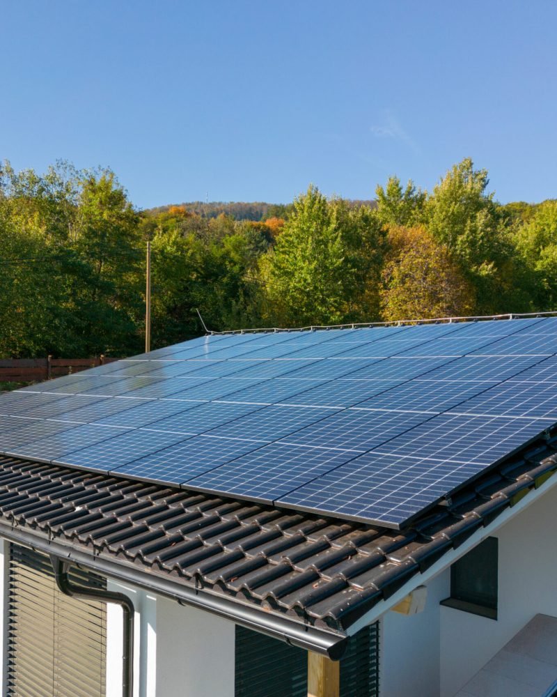 High angle view of solar photovoltaic panels on a roof, alternative energy, saving resources and sustainable lifestyle concept.