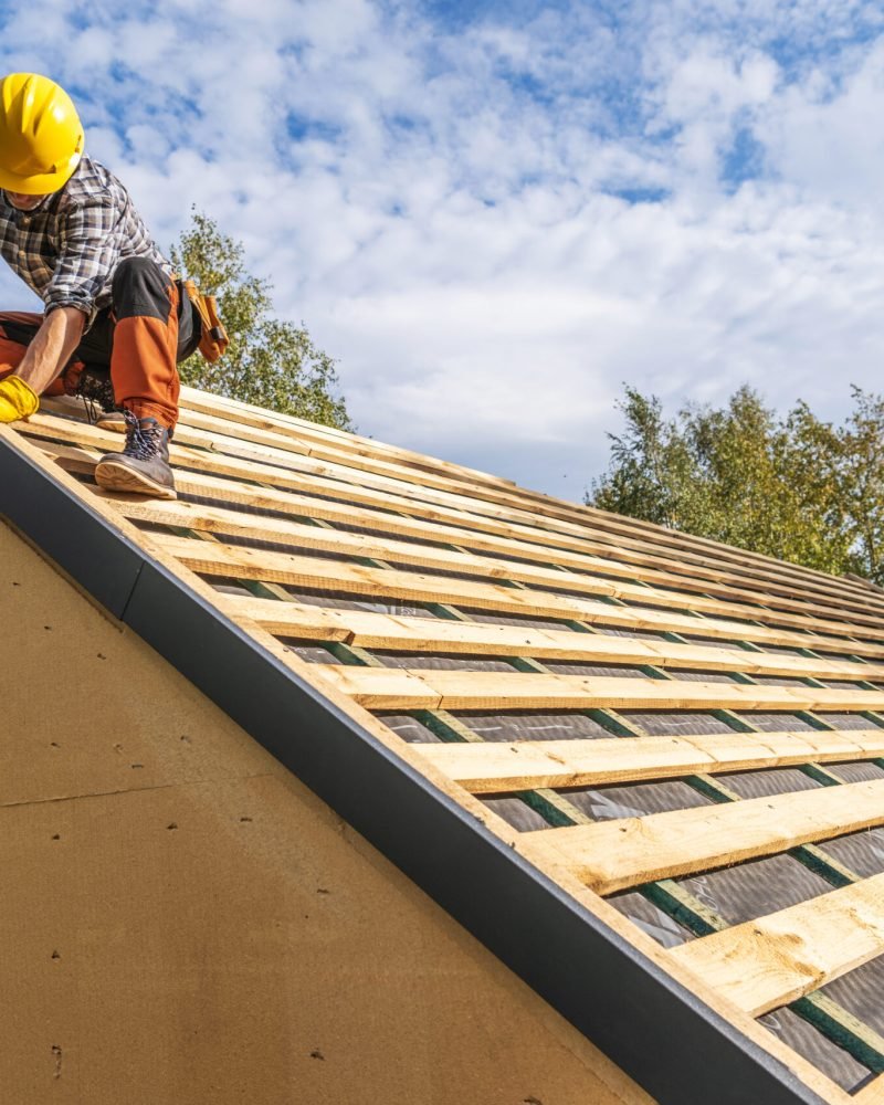 Professional Caucasian Construction Worker Wearing Hard Hat Assembling Roof Wooden Elements